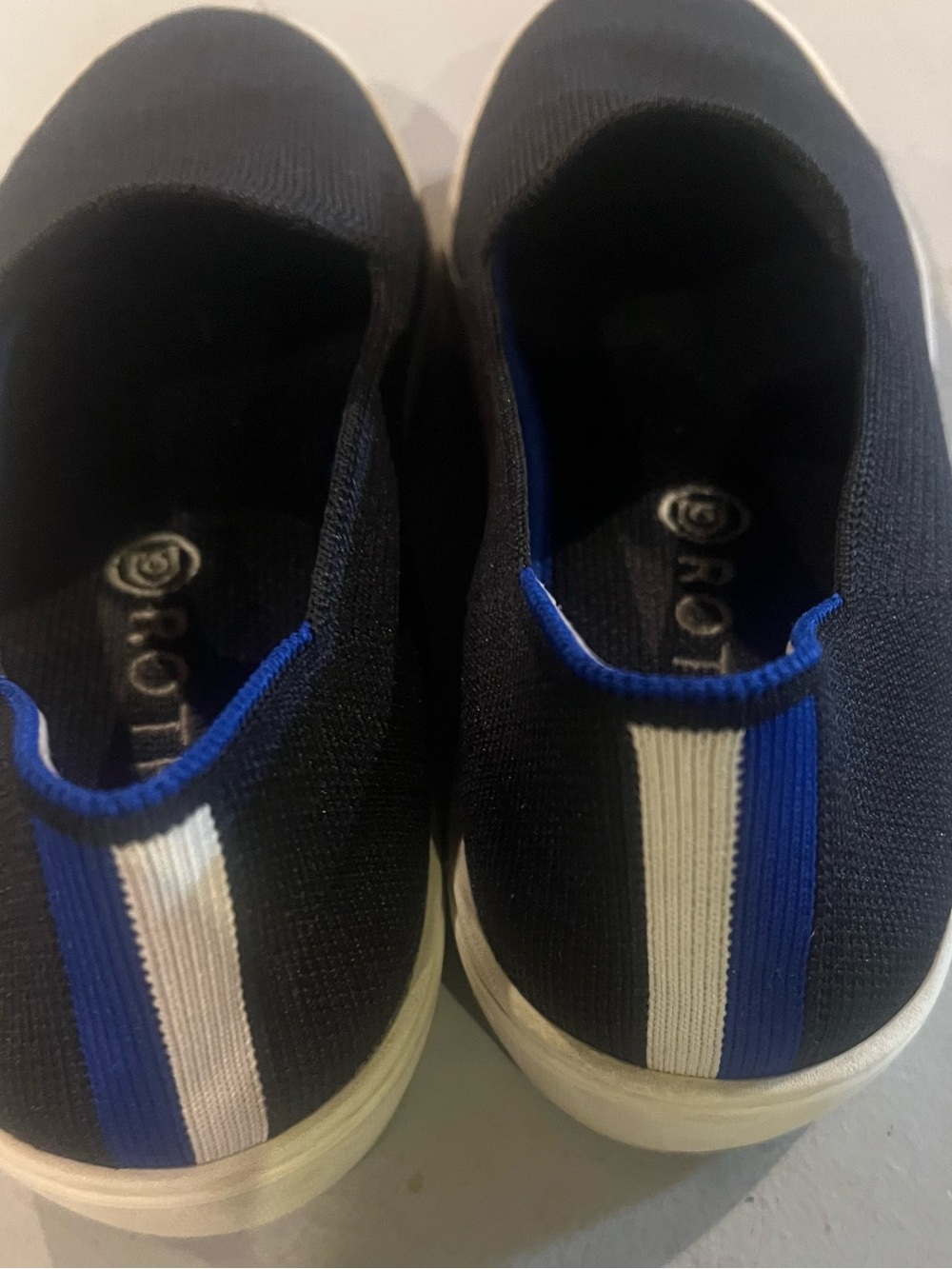 Women’s Rothy’s Slip-On Knit Sneakers in Black with White and Blue Stripe